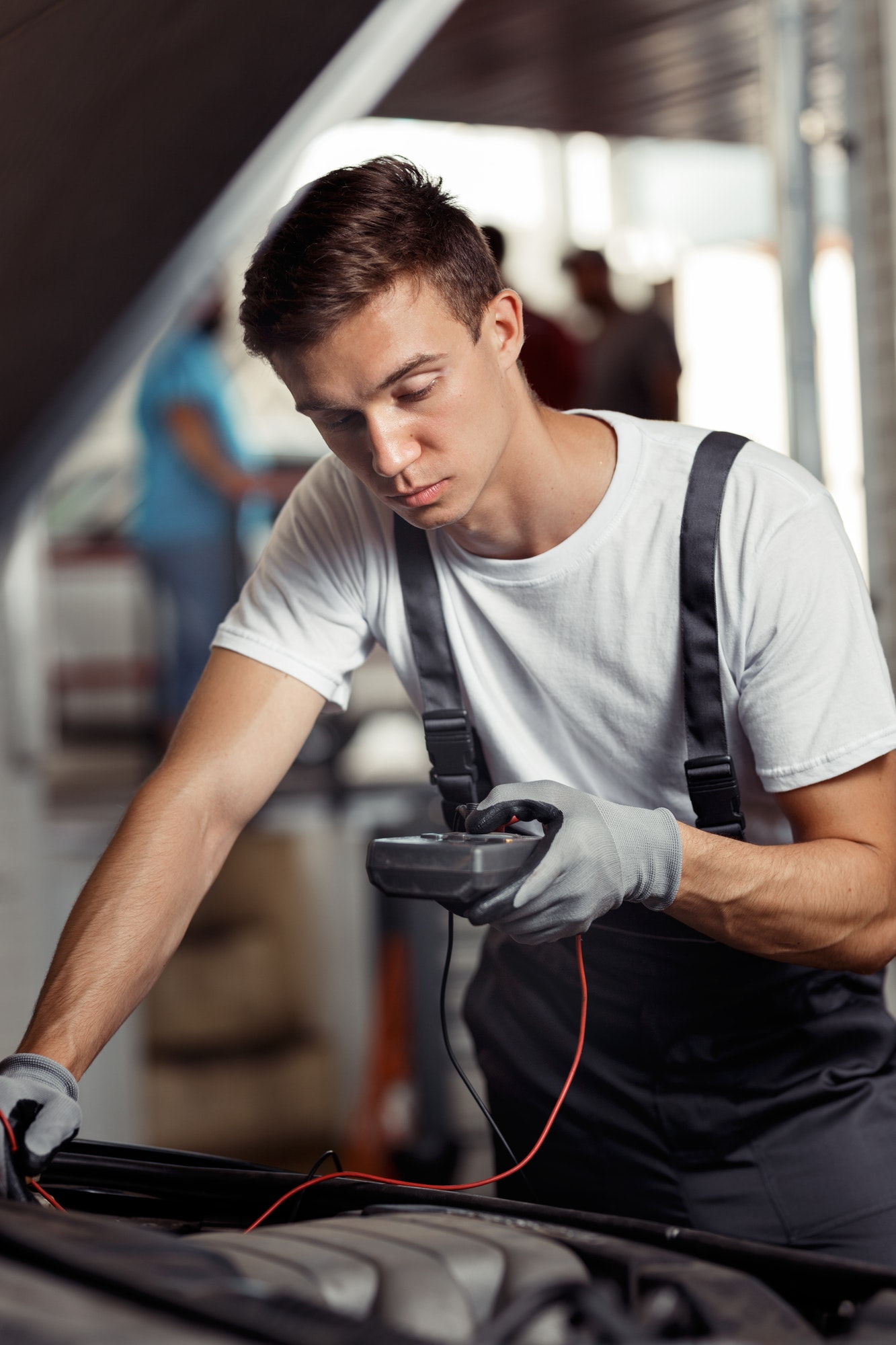 an-attractive-car-mechanic-is-checking-the-results-of-his-work-at-a-car-repair-service.jpg An Attractive Car Mechanic Is Checking The Results Of His Work At A Car Repair Service.jpg